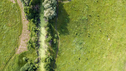 Aerial view of the field with roads and wood.