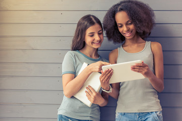 Attractive teenage girls with gadgets