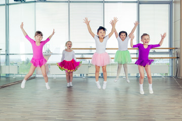 Fototapeta na wymiar happy children dancing on in hall, healthy life, kid's togetherness and happiness concept