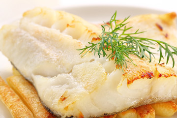 Baked fish and chips on white plate