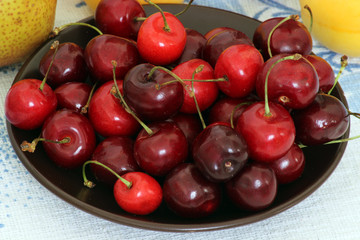 Cherry. Ripe sweet cherries. Close up of fresh strawberries on wooden background. Red delicious cherries on white napkin on wooden table. Organic healthy food.