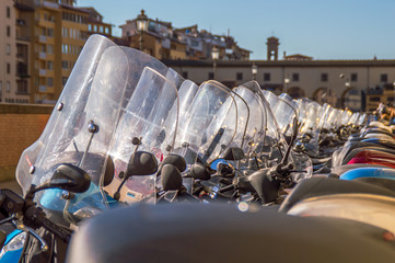 Scooters or motorbikes parked in a line