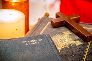 Old antique Holy Bible New Testament with a wooden cross