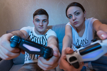 Young fasionable couple simulating the game steering movement si