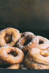 Homemade donuts with sugar and sugar powder in old metal background. 