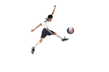 Fototapeta na wymiar Soccer player jumping while kicking the ball