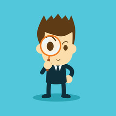 businessman looking through a magnifying glass