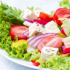 Salad from fresh vegetables with feta cheese  closeup