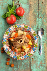 Homemade chorba soup with lamb meat on bone, potato, carrots and