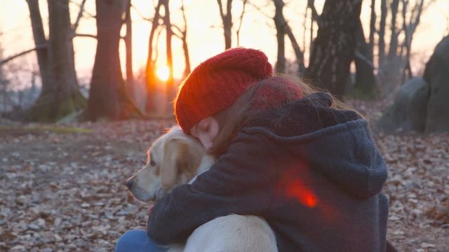 Best Friends - Teenage girl and her dog are having a break at sunset on a winter day