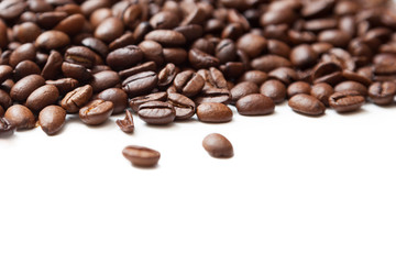 Roasted coffee beans pile from top on white background