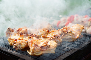 Chicken legs being fried on grill