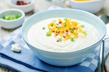 smashed cauliflower with crispy bacon, cheddar and green onions