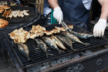 Fish mackerel and chicken tabaka grilled at bbq