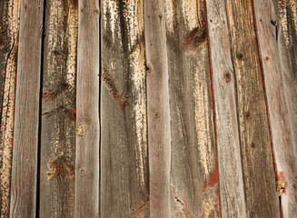Wooden siding with noted wood and old red paint from historical barn