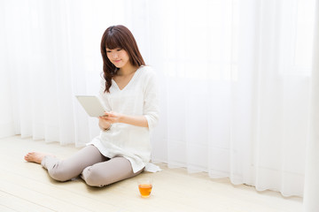 attractive asian woman using tablet computer