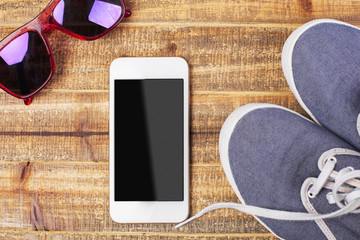 Glasses, sneakers and smartphone