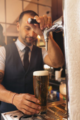 Barman serving beer in a pub.