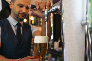 Barman serving beer in a pub.