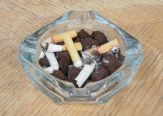 cigarette with an ashtray on the wood table