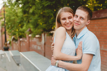 Obraz premium Portrait of Happy Couple Hugging Laughing Bricks Wall Background