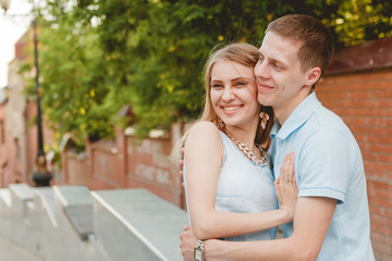 Portrait of Happy Couple Hugging Laughing Bricks Wall Background