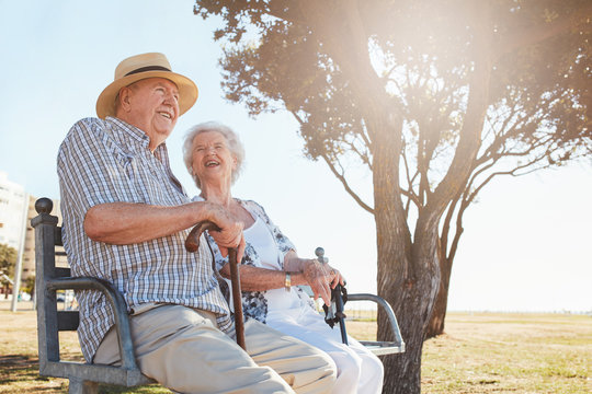 Relaxed senior couple sitting on a park bench