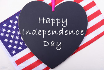 Happy Fourth of July blackboard and flag.
