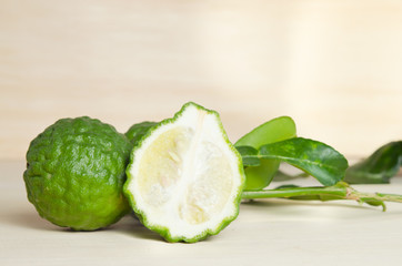 Fototapeta na wymiar Bergamots fruit with leaf on wooden board