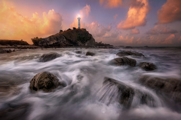 Obraz na płótnie Canvas Lighthouse Seascape during sunrise. Beautiful natural summer sea