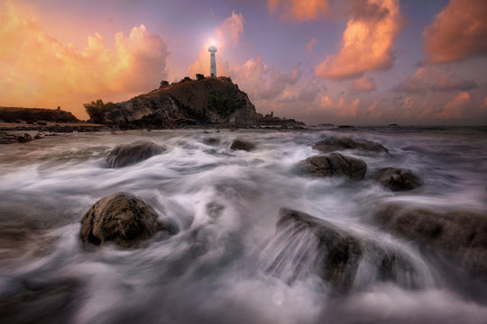 Lighthouse Seascape during sunrise. Beautiful natural summer sea