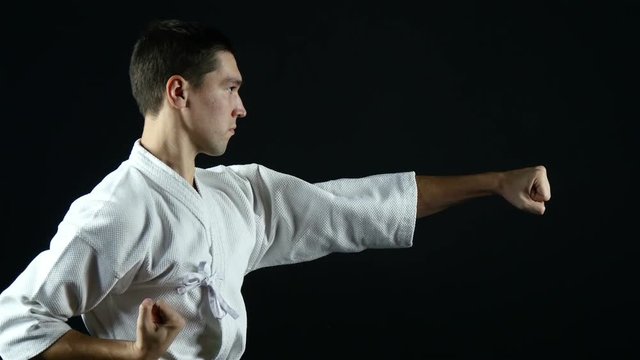 karateka in kimono practice  punches