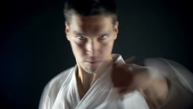 karateka performs  punches