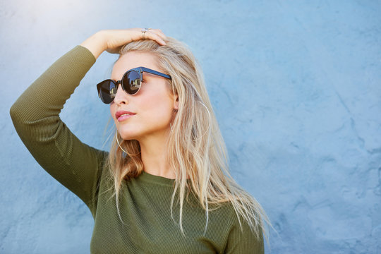 Young blonde in sunglasses looking away