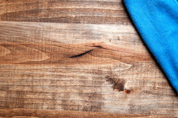 Blue microfiber cloth on a wooden background