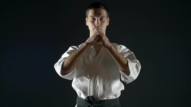 karate with a black belt makes a bow, slow motion