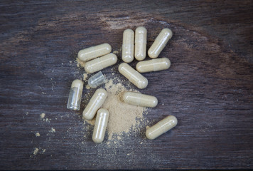 many capsule pill on wooden background