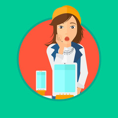 Woman looking at digital tablet and smartphone.