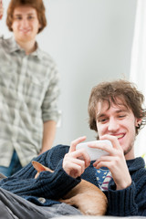 Happy young man holding chihuahua in arms
