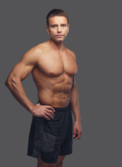Shirtless male isolated on grey background.