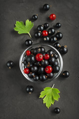 Black and red currants in a glass bowl