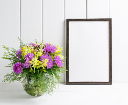 Flowers in glass vase with motivational frame