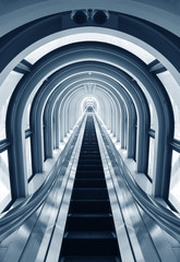 Futuristic tunnel and escalator of steel and metal, interior view. Futuristic background, business...
