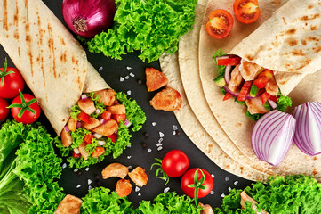 Burrito with grilled chicken and vegetables (fajitas, pita bread