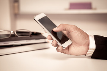 Businessman is using smart phone,tablet,cellphone in the office