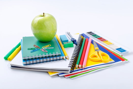 School supplies with green apple