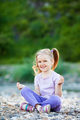 Little girl meditates, outdoor
