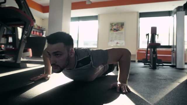 Young Male Athlete Doing Push Ups In The Gym