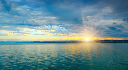 Dawn above sea and blue sky