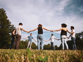 large group of friends tohether in a park having fun